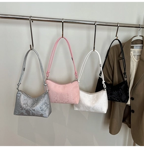 Collection of crescent-shaped shoulder bags with textured faux snakeskin in four colors