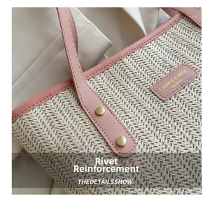 Detail of straw tote bag showing pink leather edge and gold rivet reinforcement