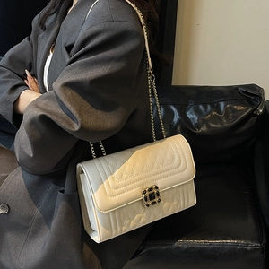 Chic cream quilted crossbody bag with gemstone buckle and gold chain strap for women