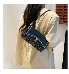 Detail of a chic shoulder bag featuring black leather and colorful sequin contrast textures