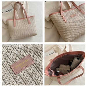 Detail of straw tote bag showing large capacity for umbrella, wallet and phone