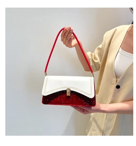 Detail of elegant two-tone handbag featuring white leather and dark red shimmer finish