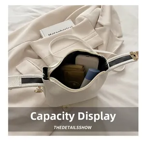 Detailed interior of the white textured faux-snake skin bag showing its storage capacity
