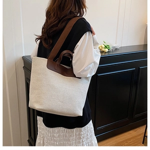 Detail view of the large linen tote bag showing contrasting straps and spacious design