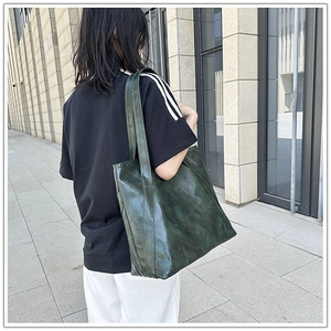 Detail view of dark green retro oily leather tote bag showing large capacity and strap