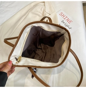 Interior view showing the large capacity, brown lining, and gold zipper of the tote bag