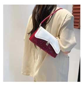 Close-up of contrast color handbag with white leather and red glitter texture detail