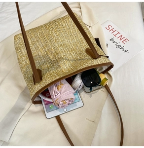 Straw tote bag showing spacious interior with iPad, umbrella and sunglasses storage