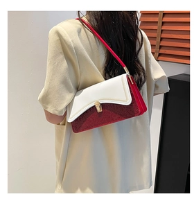 Detail of red sequined shoulder bag with white leather flap and gold twist lock