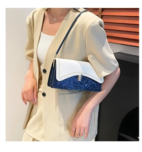 Detail of color-block shoulder bag with blue glitter panel and silver twist lock