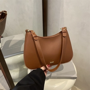 Brown minimalist vintage half-moon underarm bag with gold metal logo and adjustable strap