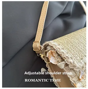 Detail view of the adjustable tan leather strap and woven texture on the straw crossbody bag