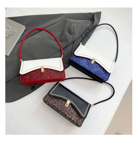 Close-up of contrast color shoulder bags with glitter base and matte leather top flaps