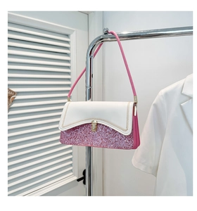 Close-up of pink sequin texture and white leather flap with golden push-lock buckle