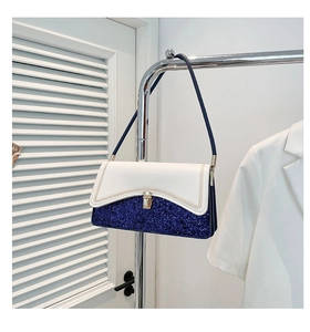Detail of blue sequined handbag with white leather flap and golden push-lock closure