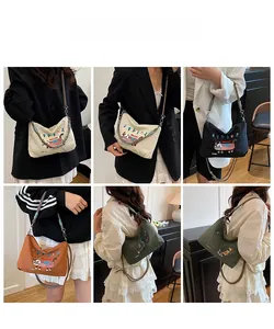 Detail view of large capacity canvas crossbody bag with colorful cat embroidery patterns