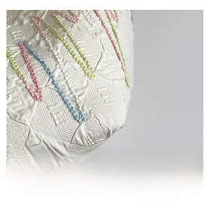 Close-up of premium white jacquard fabric with colorful wave embroidery and texture