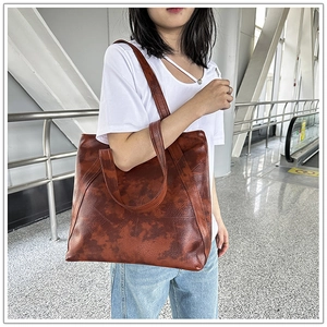 Detail of vintage brown tote bag with marble texture shown in commute travel setting