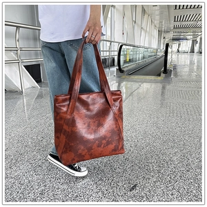 Close-up of a large capacity retro brown faux leather tote bag for daily commuting needs