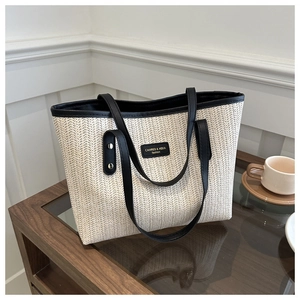 Chic woven straw tote bag with black leather trim and handles for women's spring style