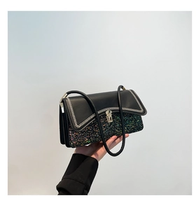 Detail of color-block handbag with black leather flap and iridescent sequin texture