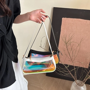Detail view of transparent holographic PVC shoulder bags with black and white trims