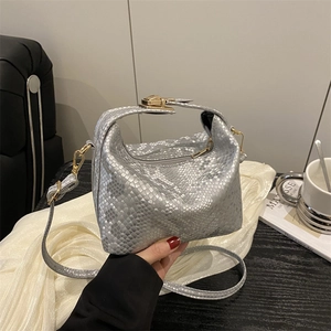 Chic silver snake pattern crossbody bag with golden hardware and top handle for spring 2025