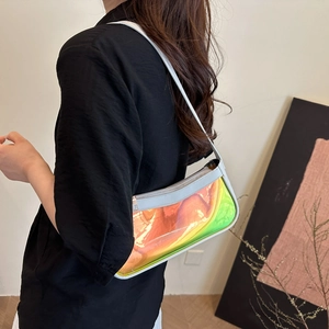 Detailed side view of a holographic shoulder bag with rainbow iridescent reflection