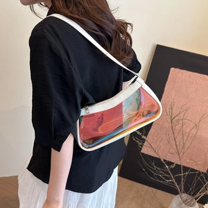 Iridescent semi-transparent baguette bag with white leather trim shown on shoulder