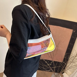 Close-up of iridescent PVC shoulder bag with white leather trim worn by a model