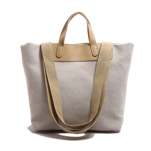 Large capacity canvas tote bag with beige woven body and brown leather handles
