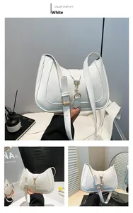 Macro shot of white patent leather hobo bag with gold hardware and adjustable strap