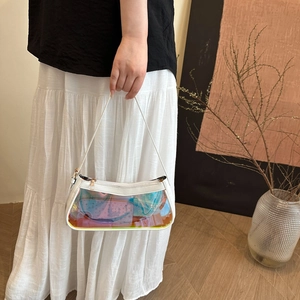 Detail of holographic clear panel on white shoulder bag with iridescent finish