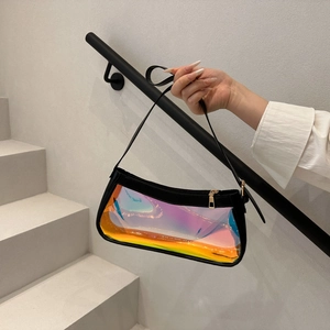 Detailed close-up of iridescent PVC shoulder bag with black leather trim and golden zipper