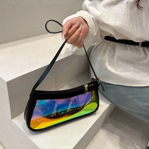 Close-up of holographic PVC baguette bag with black trim held by model on minimalist stairs