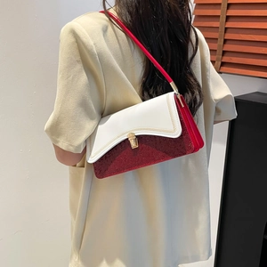 Modern color-block shoulder bag with white leather flap and sparkling red finish
