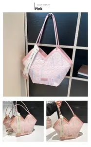 Detail of pink tote bag with V-shaped opening, quilted texture and colorful wave embroidery