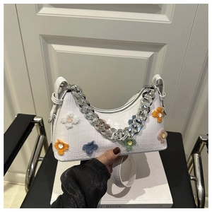 White croc-effect baguette bag with colorful plush flowers and silver chain handle detail