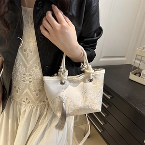 Retro Chinese style embroidered bucket handbag with floral patterns and silk tassel
