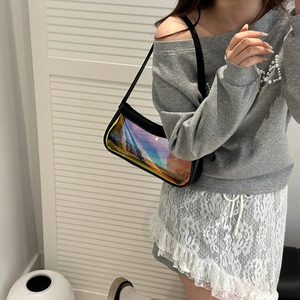 Iridescent laser material underarm bag shown with black leather trim on a fashion model
