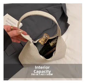 Detail view of large capacity beige woven tote bag interior showing perfume bottles