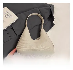 Detail of cream woven textured faux leather handbag with fine cross-weave craftsmanship