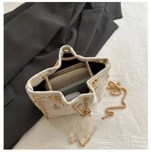 Interior view of floral lace bucket bag showing storage for phone, wallet and earphones