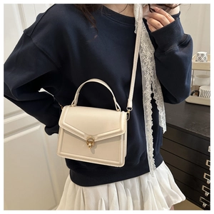 Chic beige crossbody bag with gold twist lock shown on a model in Korean style outfit
