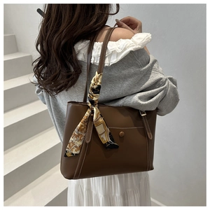 Detail of dark brown tote bag with vintage printed silk scarf on the handle