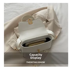 Macro view of white minimalist handbag interior showing storage for phone and wallet