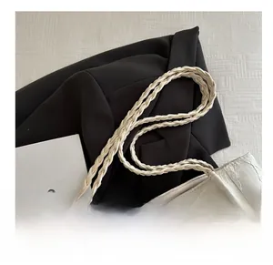 Detailed close-up of woven handles and floral jacquard fabric on the cream tote bag