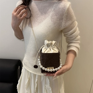 Brown snakeskin bucket bag with pearl handle and white inner pouch for women