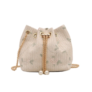 Summer woven bucket bag with floral embroidery, drawstring closure and chain strap