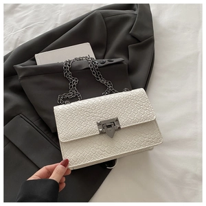 Detail of white stone pattern crossbody bag featuring black metal chain and matte lock
